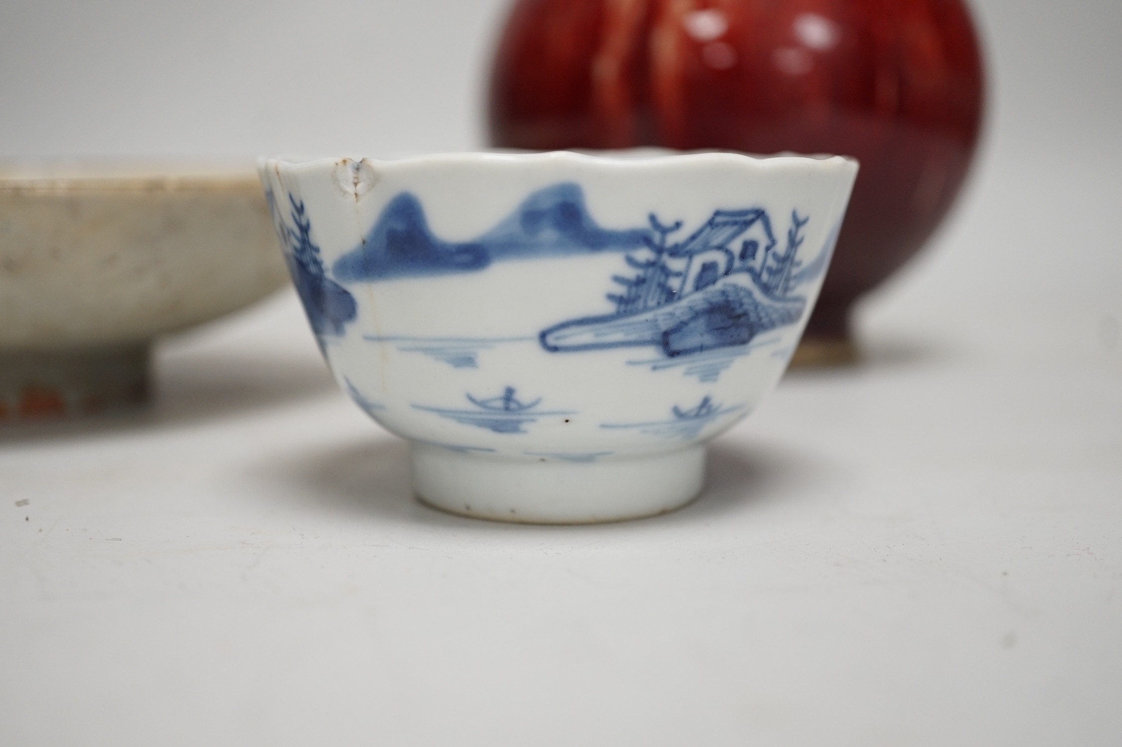 A Chinese sang de boeuf glazed bottle neck vase, together with a Chinese blue and white tea bowl, and a Chinese dish, tallest 23cm